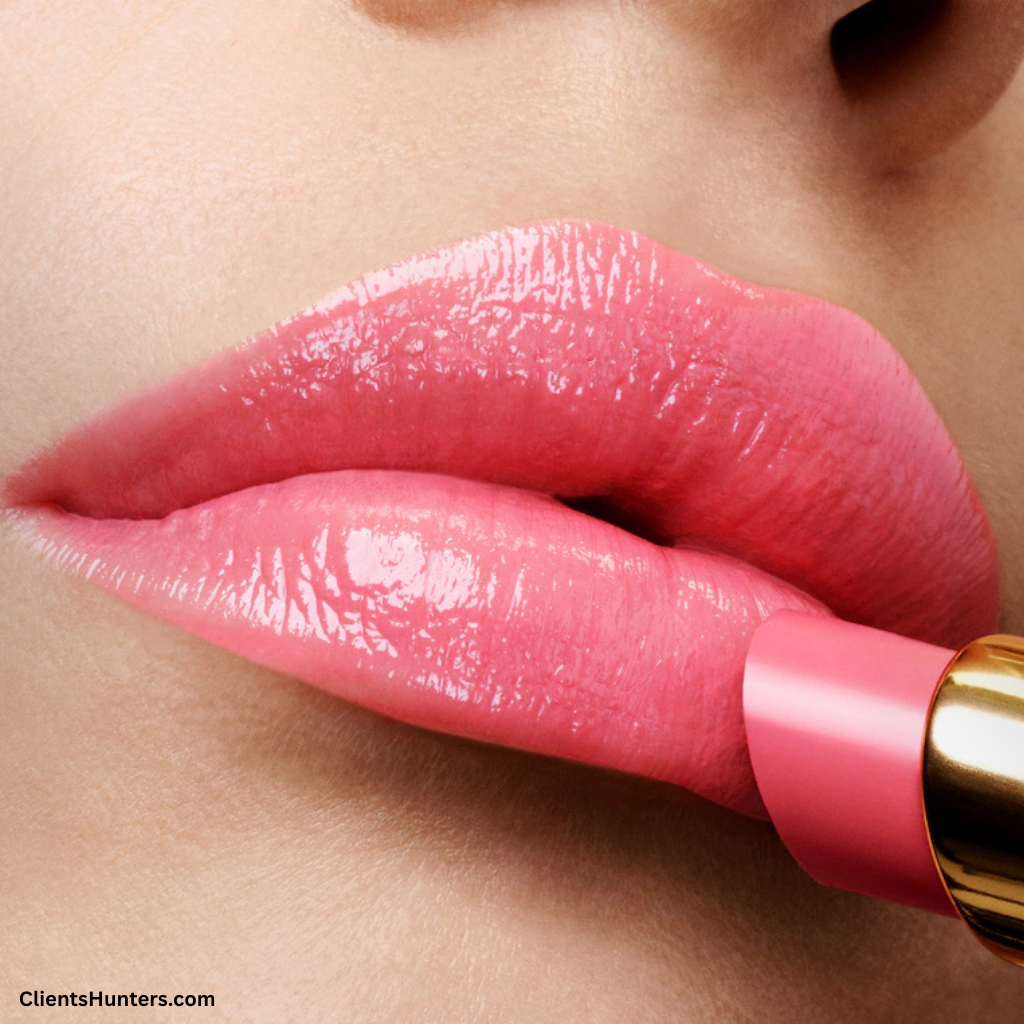 Close-up of glossy pink lips wearing Tom Ford Soleil Ultra-Shine Lip Color, with lipstick being applied.
